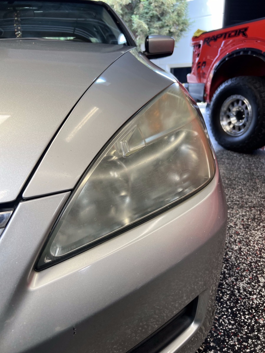 Hazy, yellowed headlight before restoration
